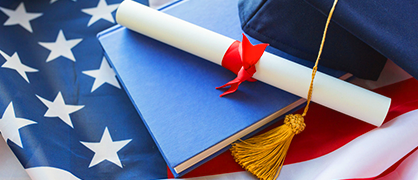 Graduation cap and diploma on American flag